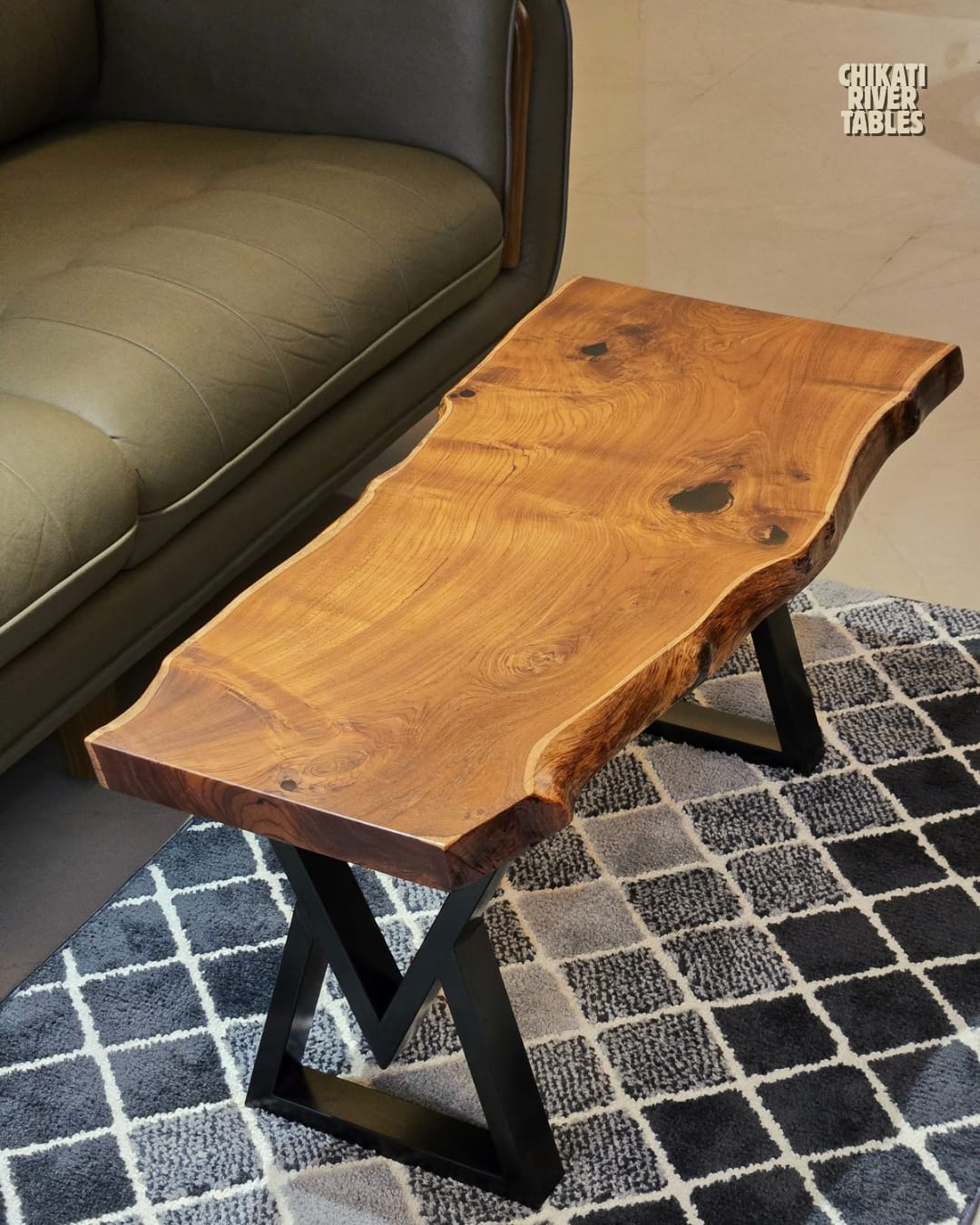 Live-edge teak slab table with no resin on black metal legs