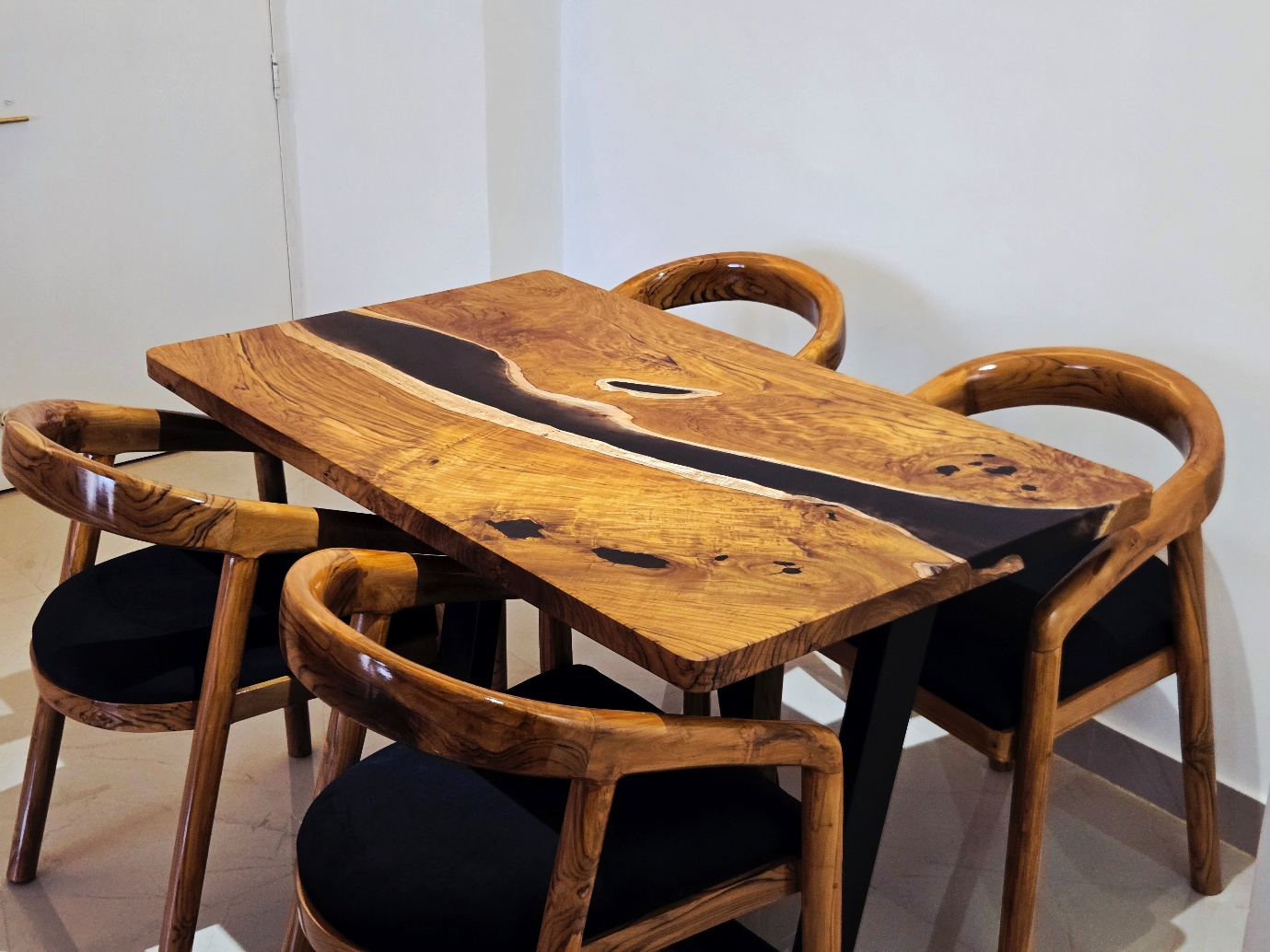 Teak dining table with a dark resin river