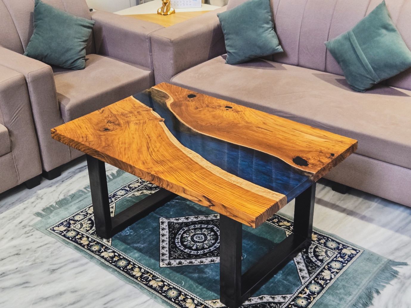 Teak table with flowing blue resin